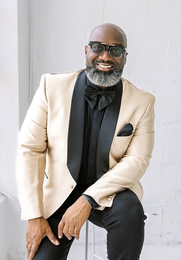 Cleveland in a cream tuxedo jacket with black bow tie